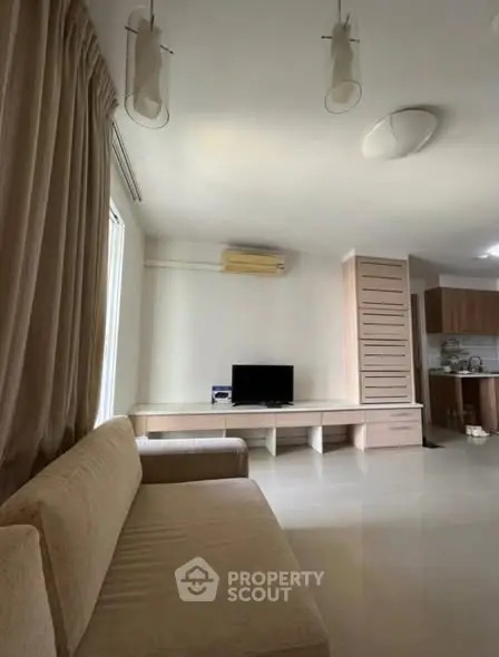 Spacious living room with modern decor and open kitchen layout