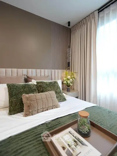 Luxurious bedroom with elegant decor and plush bedding in modern apartment.