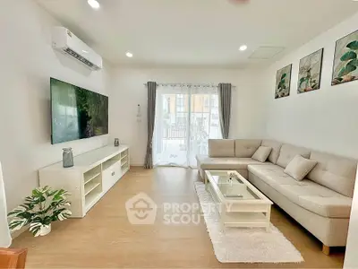 Modern living room with large TV, cozy sectional sofa, and stylish decor
