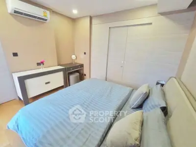 Modern bedroom with stylish decor and air conditioning in a cozy apartment.