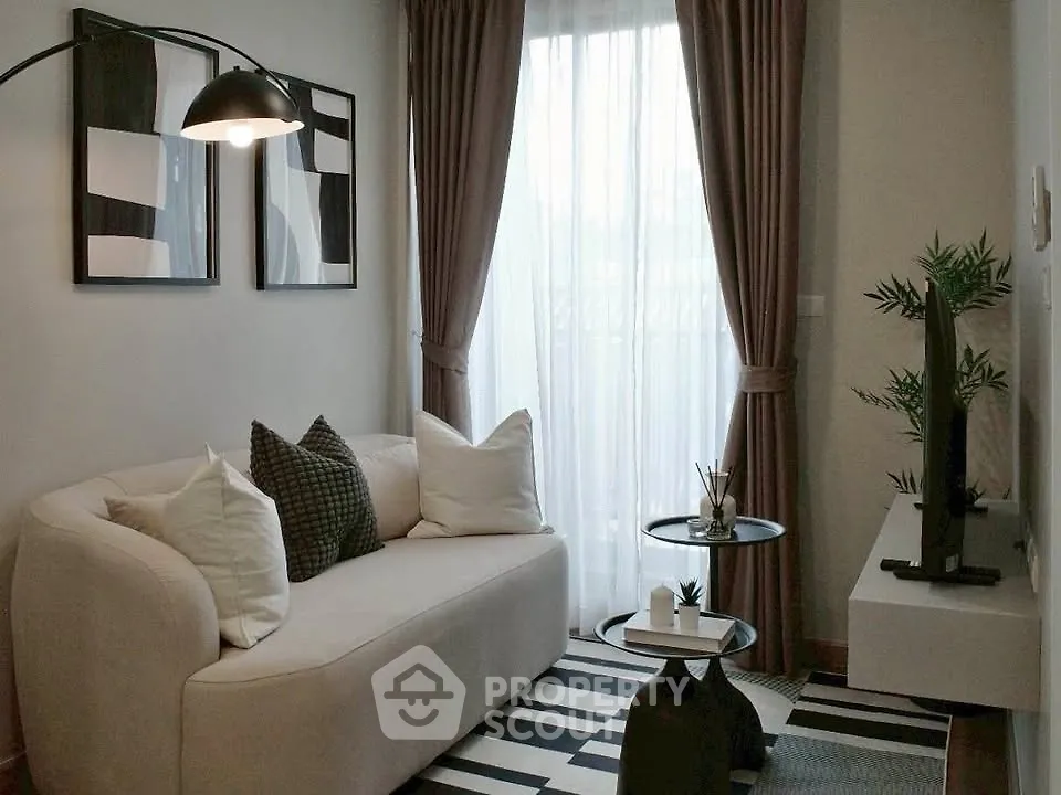 Stylish modern living room with cozy sofa, elegant decor, and natural light.