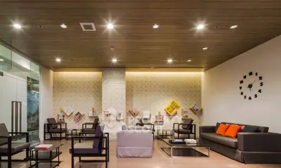 Modern living room with stylish seating and wall decor