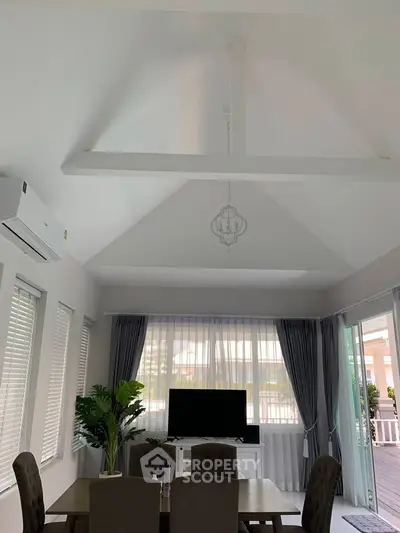 Spacious living room with vaulted ceiling and modern decor