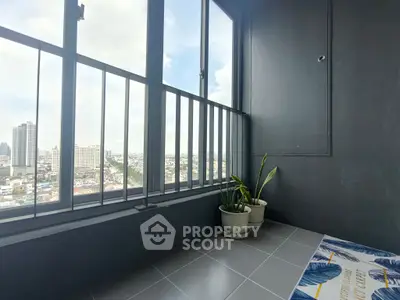Stylish balcony with panoramic city view and potted plants, perfect for relaxation.