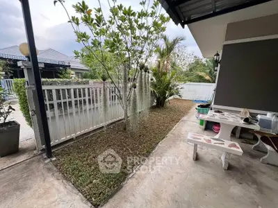 Charming outdoor garden area with lush greenery and cozy seating, perfect for relaxation and entertaining.