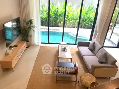 Luxurious living room with pool view, modern furniture, and floor-to-ceiling windows.