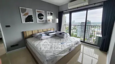 Modern bedroom with large windows and city view in high-rise apartment
