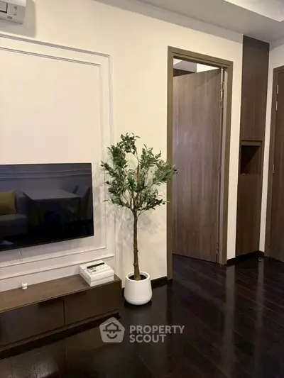 Modern living room with sleek dark wood flooring and stylish decor