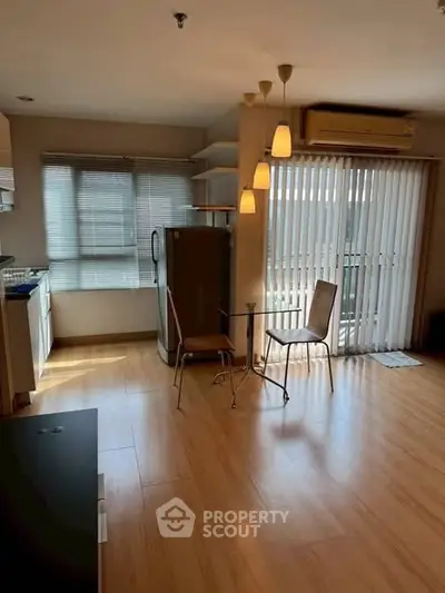 Spacious living room with natural light, modern furniture, and balcony access in a stylish apartment.