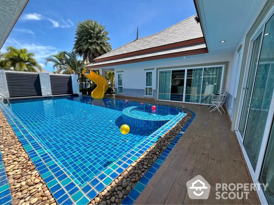 Luxurious villa with private pool and slide, perfect for family relaxation.