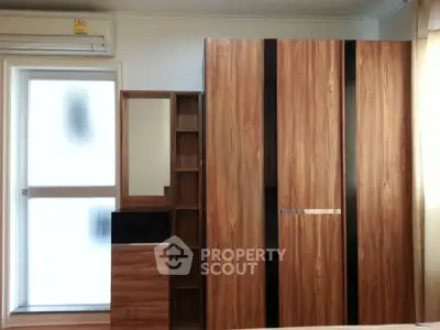 Modern bedroom with stylish wooden wardrobe and natural light