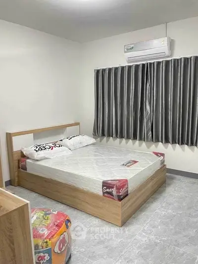 Modern bedroom with air conditioning and stylish curtains, featuring a comfortable bed and sleek flooring.
