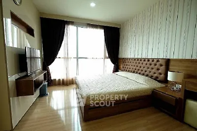Spacious modern bedroom with large window and stylish decor