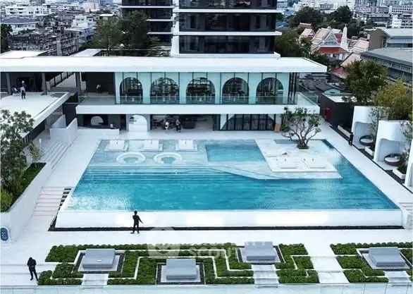 Luxurious modern apartment complex with stunning rooftop pool and city views.