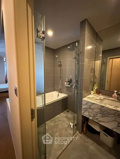 Modern bathroom with sleek design and marble countertop in a stylish apartment.