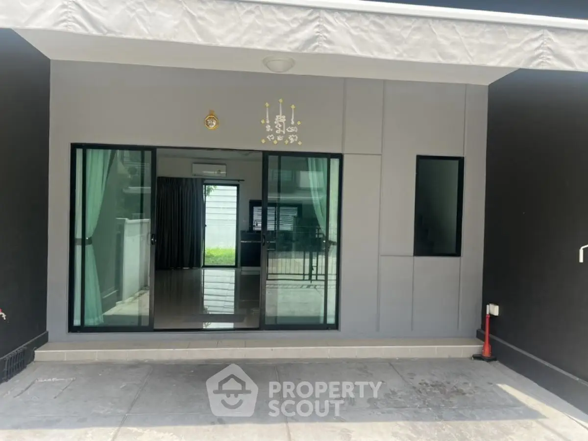 Modern house entrance with glass sliding doors and sleek design