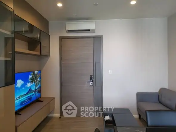 Modern living room with sleek furniture and wall-mounted TV