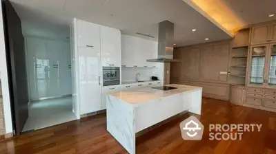 Spacious kitchen with modern appliances, ample cabinetry, and hardwood floors, ideal for culinary enthusiasts.