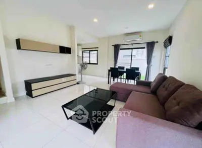 Spacious modern living room with sleek furniture and natural light.