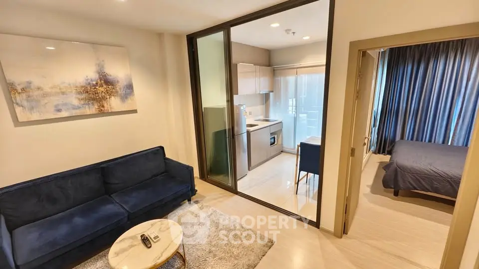 Modern apartment with open layout, featuring a cozy living room, compact kitchen, and elegant bedroom.