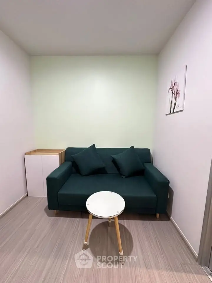 Cozy living room with modern green sofa and minimalist decor