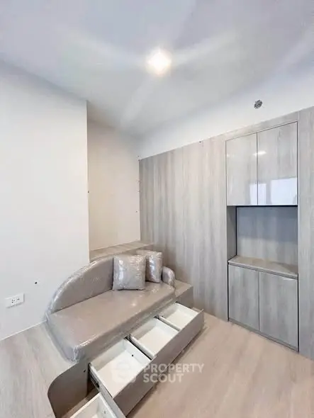 Modern minimalist living space with built-in storage and sleek design.