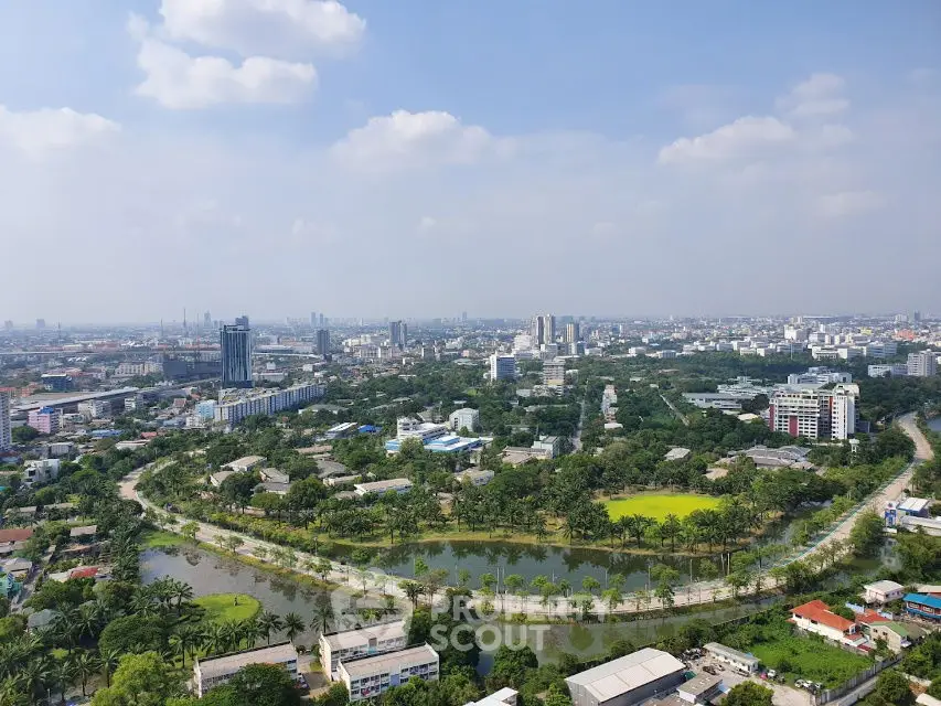 Stunning cityscape view with lush greenery and winding river, perfect for urban living.