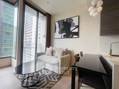 Modern living room with large windows and stylish decor in a high-rise apartment.