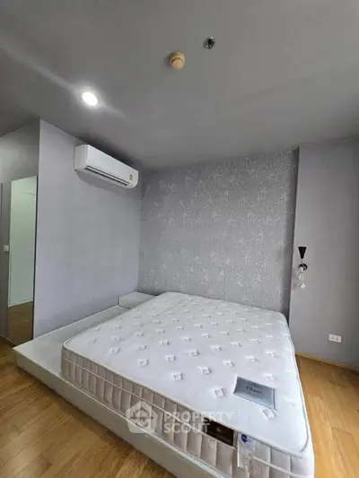 Modern bedroom with minimalist design and air conditioning in a stylish apartment.