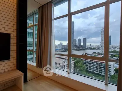 Stunning cityscape view from modern high-rise apartment window with sleek interior design.