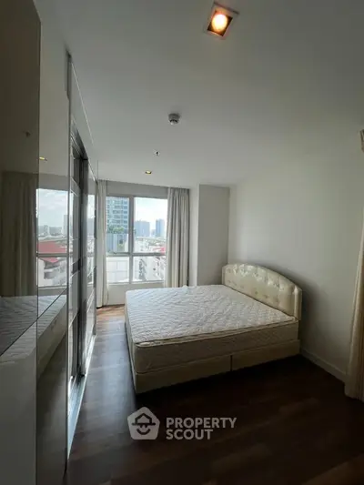 Spacious bedroom with city view and elegant decor in modern apartment