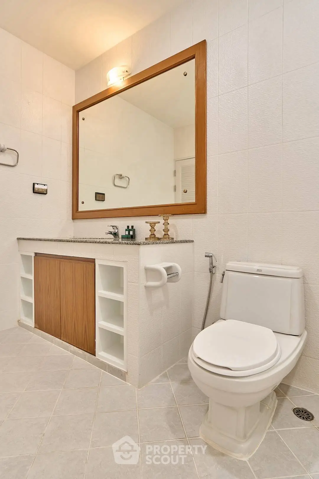 Modern bathroom with large mirror and elegant fixtures in a stylish real estate property.