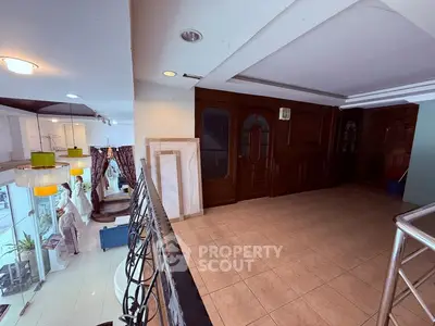 Spacious interior with elegant railing and tiled flooring, perfect for modern living.