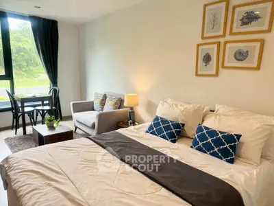 Spacious modern bedroom with elegant decor and scenic window view