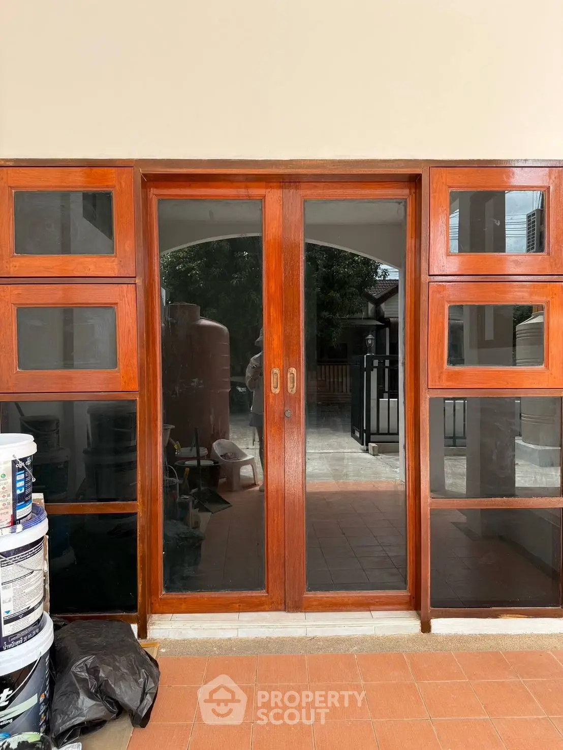 Elegant wooden sliding doors leading to a spacious patio with natural light.