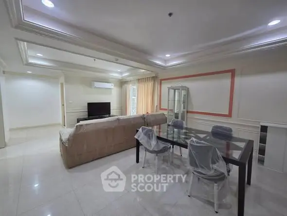 Spacious living room with modern furniture and elegant ceiling design