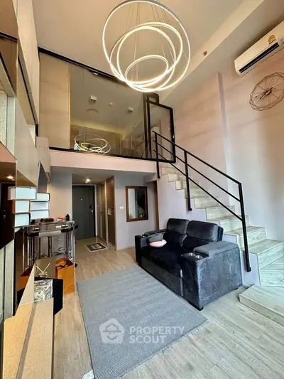 Modern loft apartment with stylish staircase and cozy living area