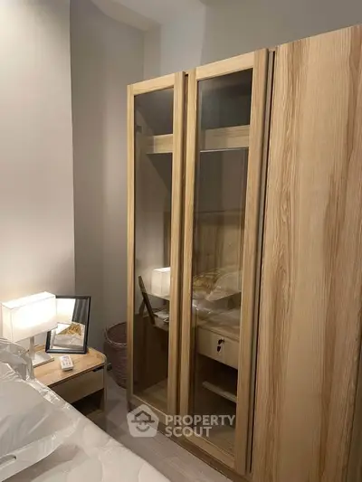Cozy bedroom with wooden wardrobe and soft lighting