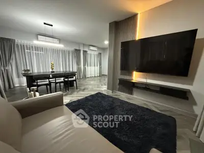 Modern living room with sleek design and large wall-mounted TV