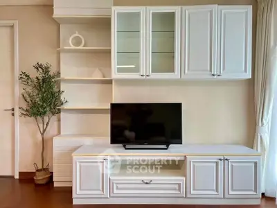 Elegant living room with modern white cabinetry and sleek TV setup, perfect for stylish home entertainment.