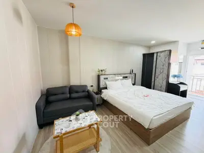 Modern bedroom with stylish decor and cozy seating area