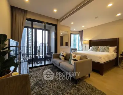 Luxurious studio apartment with balcony and city view, featuring modern decor and cozy ambiance.