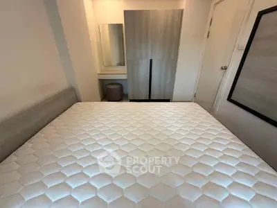 Cozy bedroom with modern furniture and comfortable mattress in a stylish apartment.
