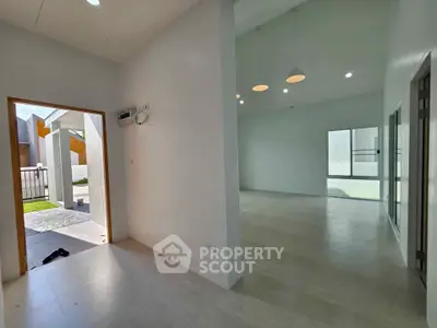 Spacious modern living area with high ceilings and ample natural light, perfect for contemporary living.