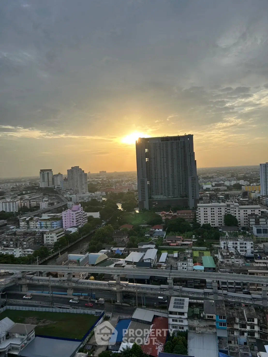 Stunning cityscape view with sunset over modern high-rise buildings.