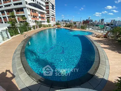 Luxurious rooftop pool with stunning city skyline views, perfect for relaxation and leisure in a prime urban location.