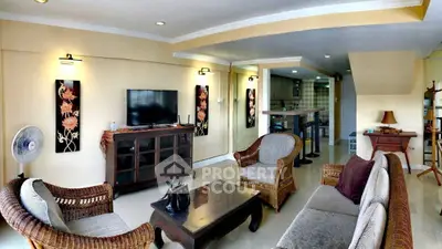 Spacious living room with elegant wicker furniture and modern decor, perfect for relaxation and entertainment.