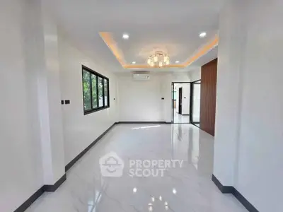 Spacious modern living room with elegant lighting and large windows