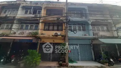 Charming multi-story building with street-level shops and residential units above.