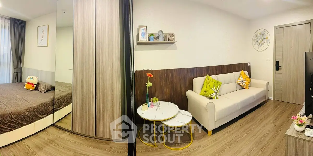 Modern living room with cozy decor and adjacent bedroom in stylish apartment